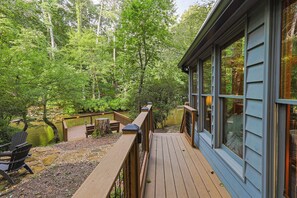 A deck with a view of a forest and a lake. - Cartecay Canoe House | Ellijay, GA (Ellijay)