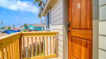 Welcome to your home away from home, featuring an entrance with a designated room number and access to a spacious outdoor deck.