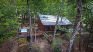 A cabin surrounded by trees with a deck and a small outdoor area. - Aska Retreat | Blue Ridge, GA (Cherry Log)