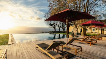 Indoor pool, outdoor pool, open 9:00 AM to midnight, pool umbrellas