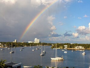 A marina with multiple sailboats docked, a clear sky, and a rainbow. - 4 Px partial sea view, - Rent.Apart.Hollywood (Hollywood)