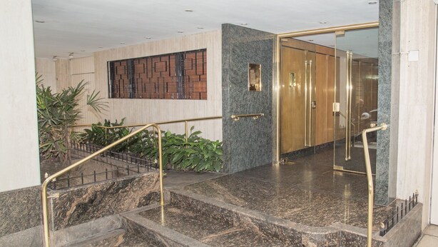 A marble staircase with a handrail, leading to a door with a glass panel. - Austria apartment by Be Local Argentina (Buenos Aires)