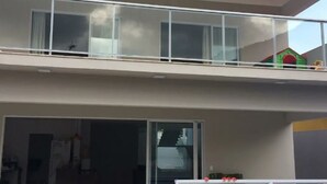 A two-story building with a balcony on the upper floor.