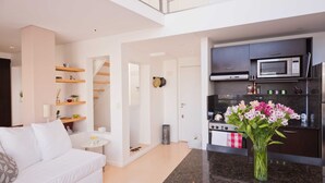 A modern apartment with a living room, kitchen, and a staircase. - Billinghurst 2 by Be Local Argentina (Buenos Aires)