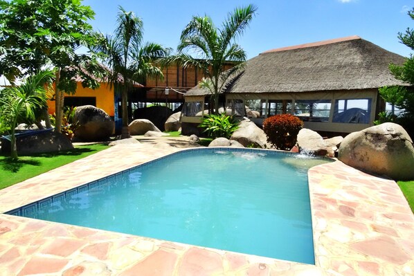 Outdoor pool, open 9:00 AM to 7:00 PM, pool umbrellas, pool loungers