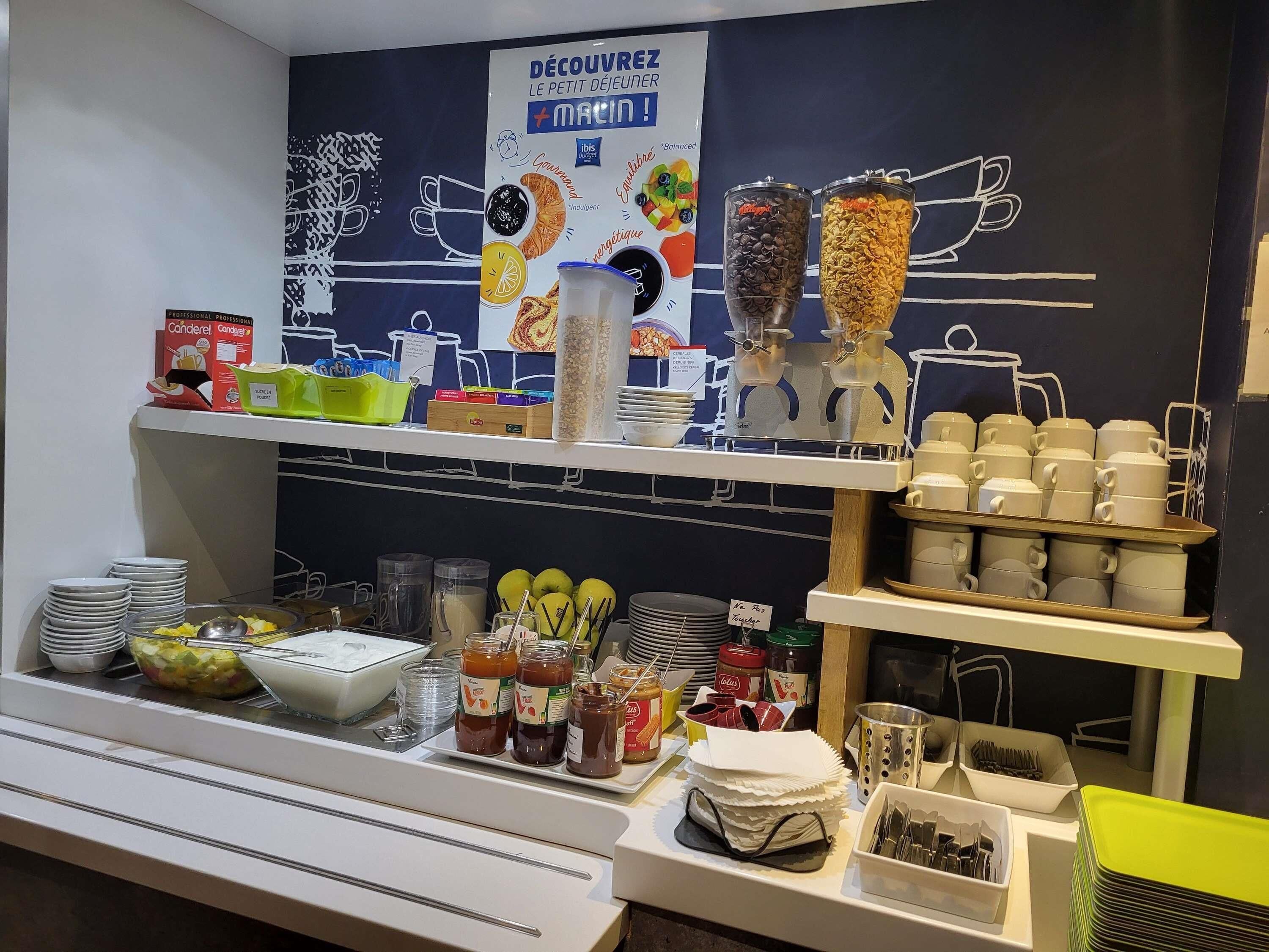 A breakfast buffet setup with various food items and condiments.