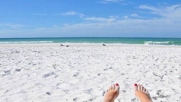 A beach with white sand and a clear blue sky. - 4BR Siesta Key lagoon home w/ heated pool (Sarasota)