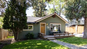 A small, single-story house with a front porch, a mailbox, and a number 1115 sign. - Spacious Layout │West Side │Walk Everywhere │Hot Tub │One Block to River (Bend)