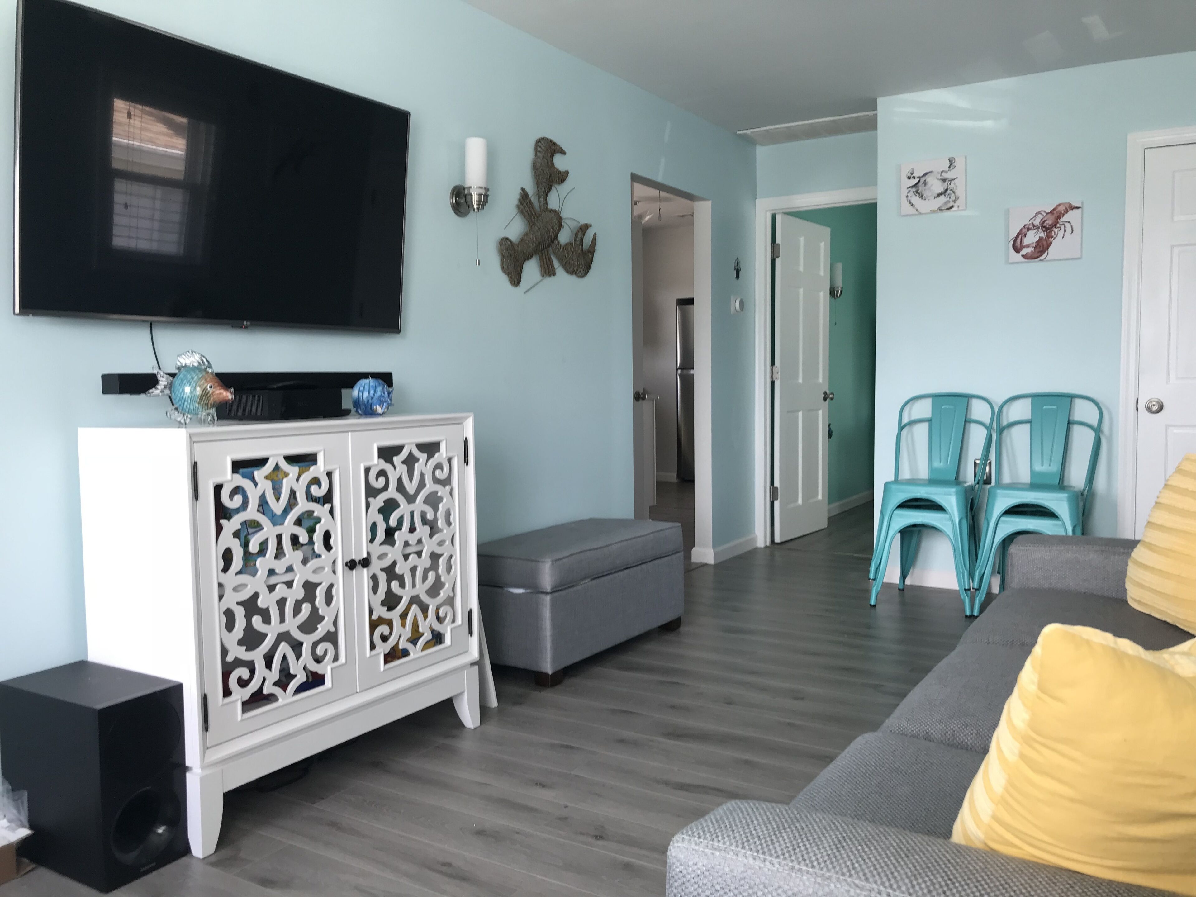 Enjoy sunsets at this modern cottage with large backyard and peekaboo bay view.