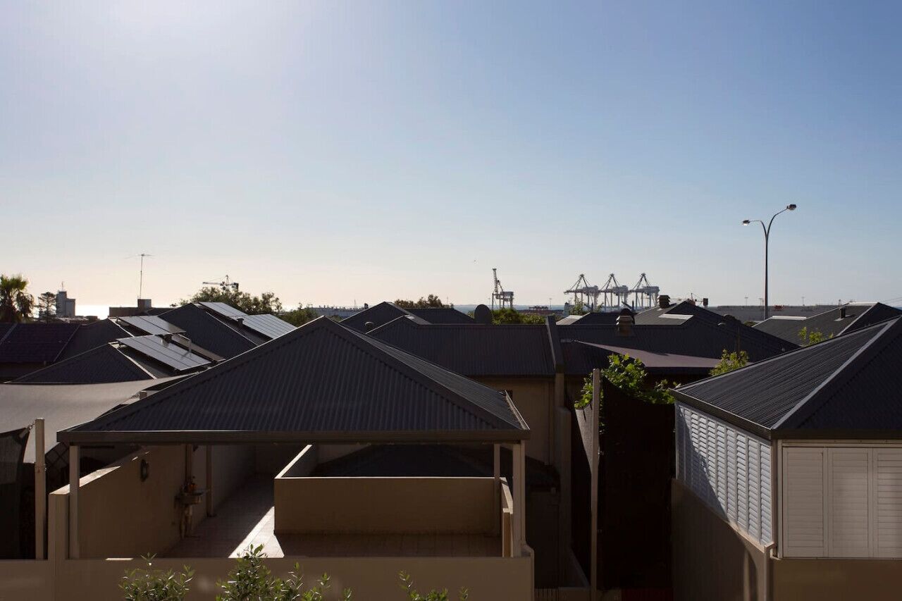 A residential area with multiple houses, each featuring a sloped roof and a small attached garage.
