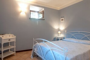 A bedroom with a bed, bedside table, and a small window. - CASALE LA FATA, FLORA delightful two bedroom pool front apartment (CAMAIORE)