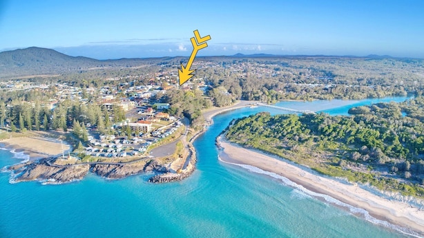 An aerial view of a coastal town with a river, beach, and forested hills. - Amble Inn - walk to the beach (SOUTH WEST ROCKS)