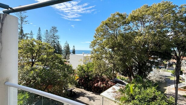 A balcony with a view of trees and a distant body of water. - Jubilee Apartment 14 (South West Rocks)