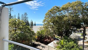 A balcony with a view of trees and a distant body of water. - Jubilee Apartment 14 - Linen supplied (South West Rocks)