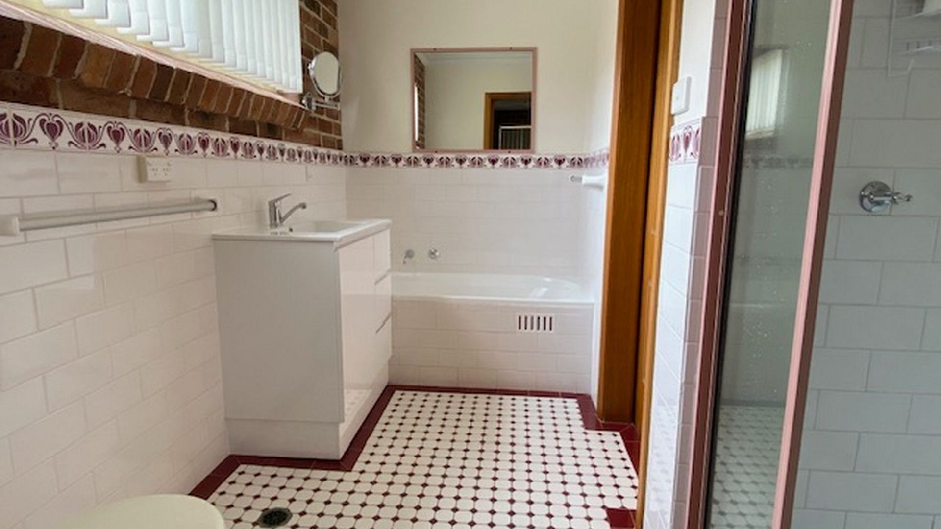 A bathroom with a white sink, a bathtub, and a shower.