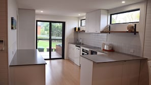 Enjoy cooking in this well-equipped kitchen with a dishwasher, sink, and countertop appliances.