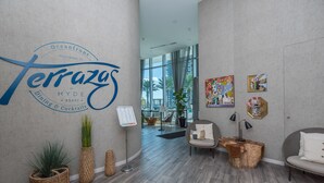 A modern interior with a sign for 'Terrazas at Hyde XXXVI' and a view of the outdoors. - Private Luxury Condos at Costa Hollywood (Hollywood)