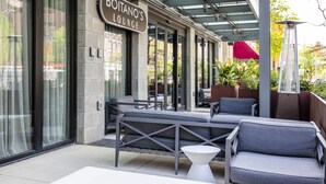 An outdoor seating area with modern furniture and a sign for "Boitano's Lounge". - The Kindler Hotel (Lincoln)