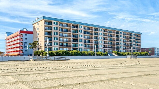 A multi-story hotel with a modern design, featuring balconies and a flat roof. - Ocean Hideaway (Ocean City)