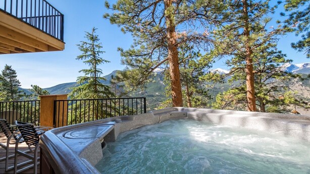 A hot tub on a wooden deck with a mountain view. - Cedar Lower Luxury Vacation At Windcliff 2 Bedroom Home by RedAwning (Estes Park)