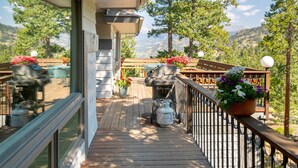 A wooden deck with outdoor seating, potted plants, and a scenic mountain view. - Werlein Family Vacation At Windcliff 4 Bedroom Home by RedAwning (Estes Park)