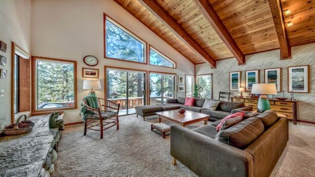 A spacious living room with a high ceiling, large windows, and a cozy seating area. - Your Roomy Northstar Retreat Awaits by RedAwning (Truckee)