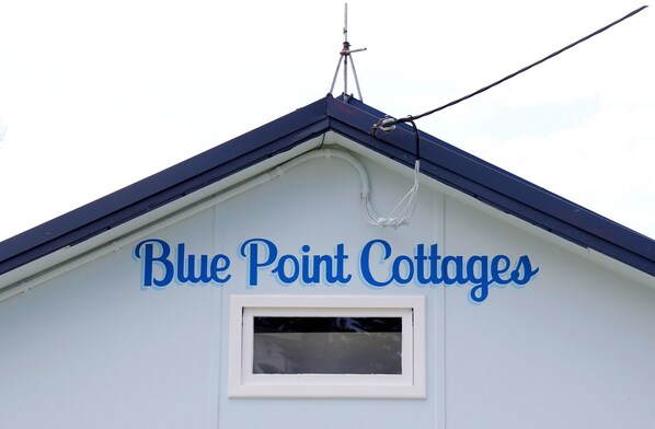 A building with a sign that reads "Blue Point Cottages". - **Blue Point Cottage No 2 Bermagui** (Bermagui)