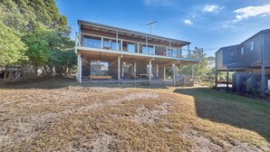 A two-story house with a balcony, a large yard, and a tree in the background. - 9 Boat Creek by the beach in Ventnor (Ventnor)
