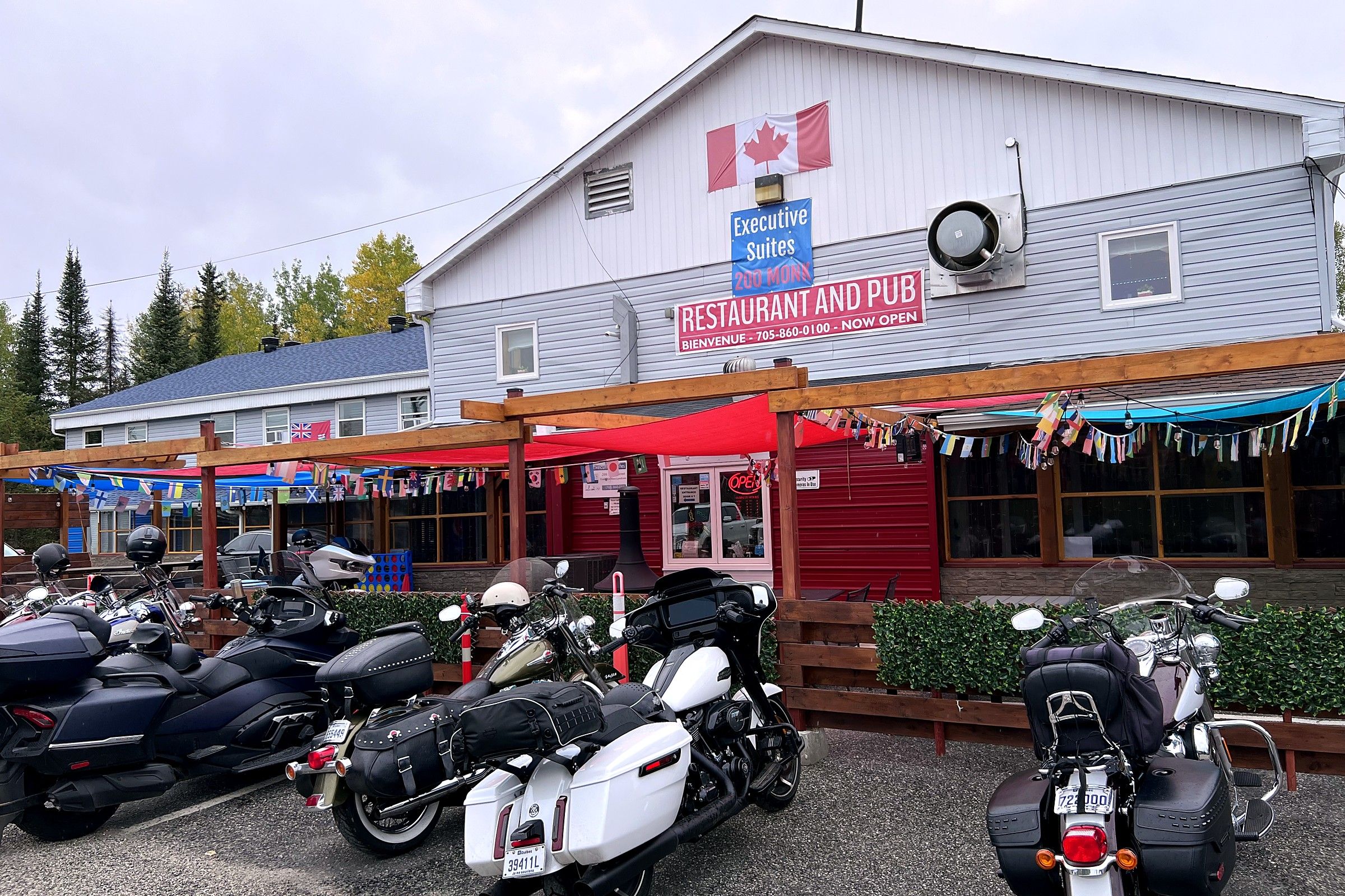 A building with a sign for 'Executive Suites 200 Monck' and a 'Restaurant and Pub' with a red awning.