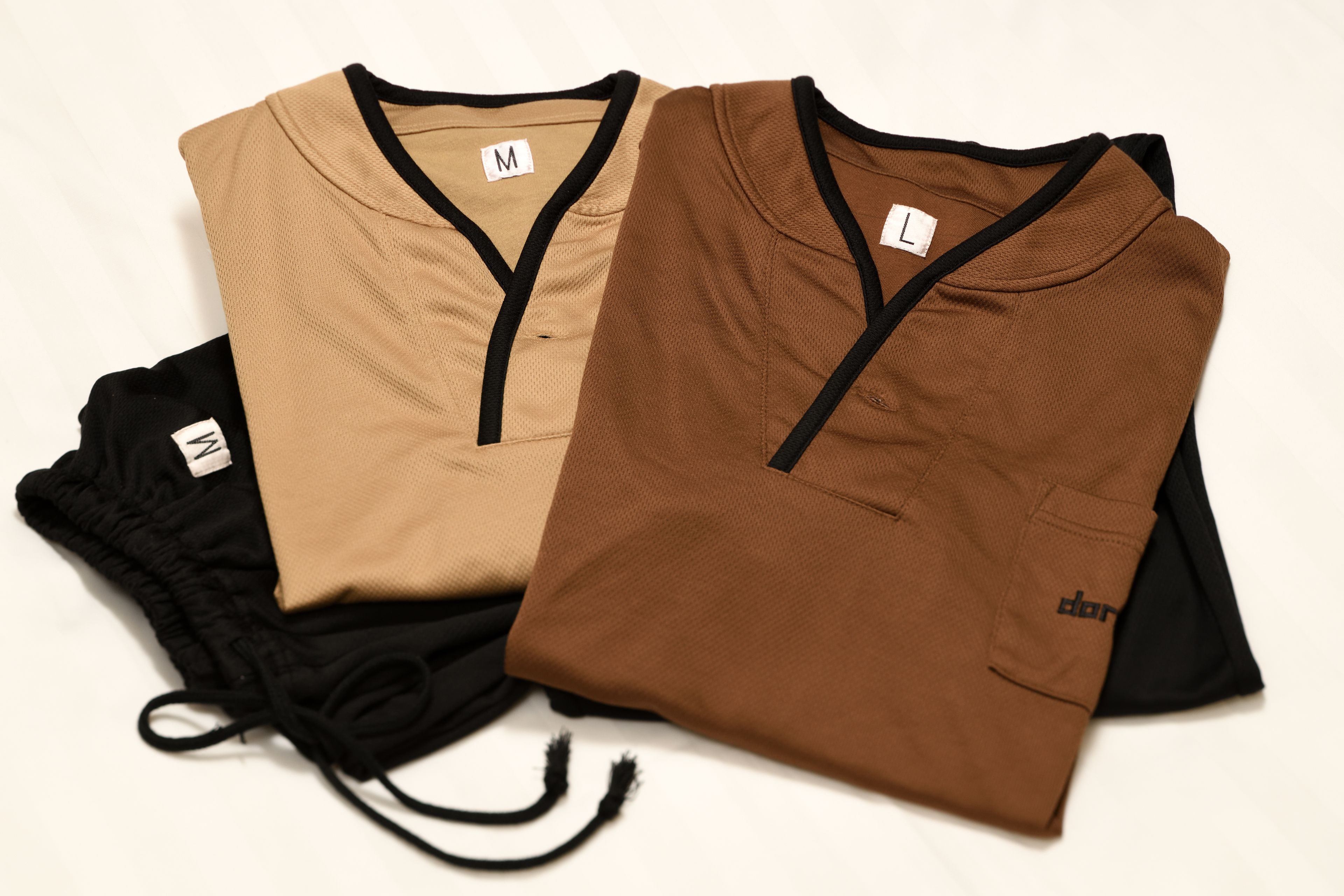 A pair of folded shirts and a pair of shorts.
