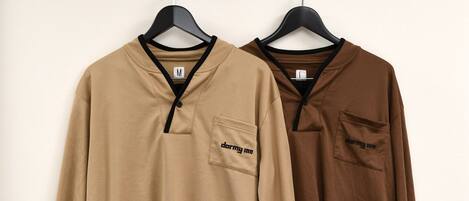 Two long-sleeved tops hanging on a rack.