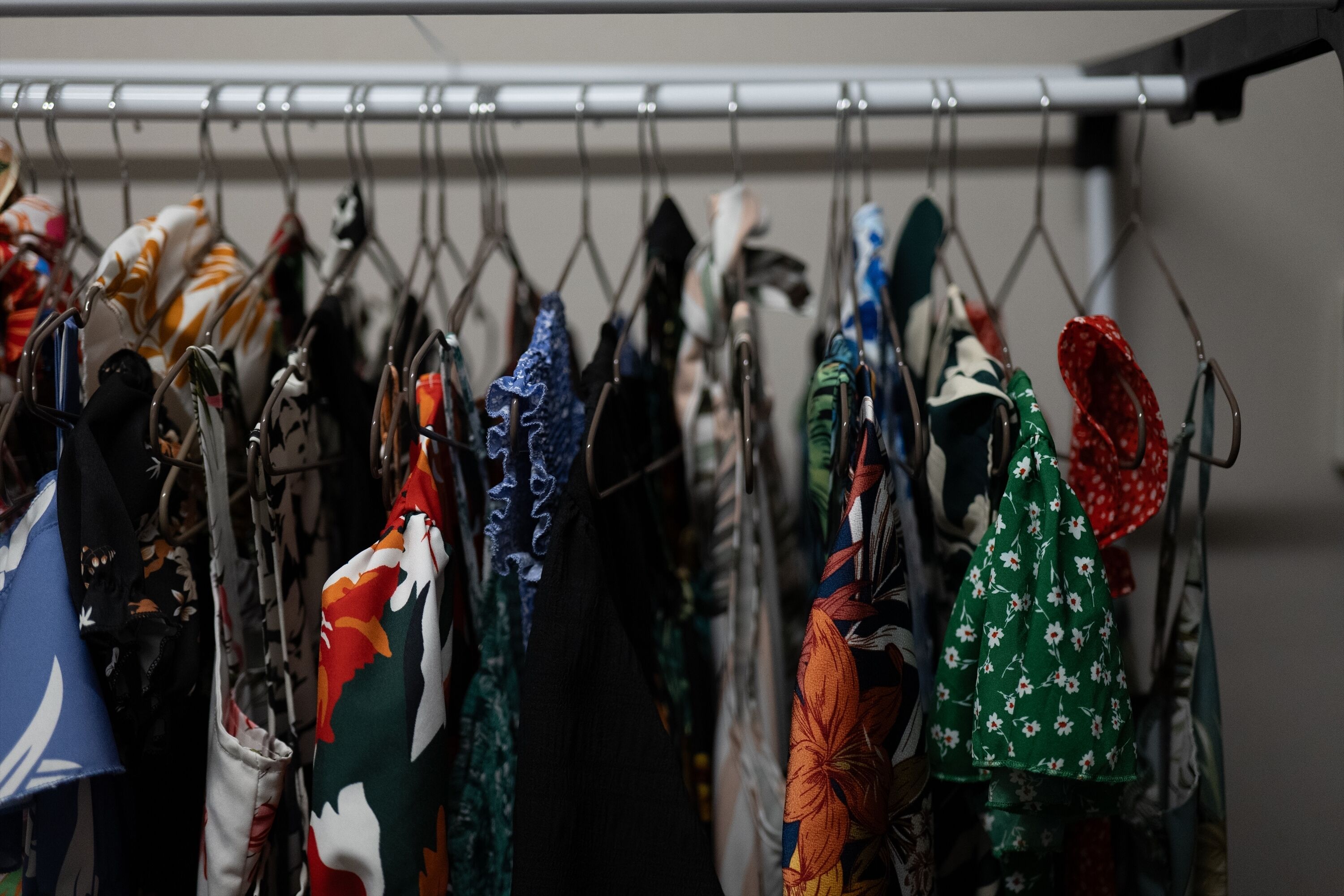 A rack of various bags and accessories hanging in a store.