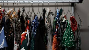 A rack of various bags and accessories hanging in a store.