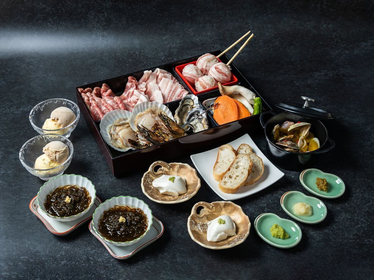 A variety of food items including seafood, bread, and condiments arranged on a dark surface.