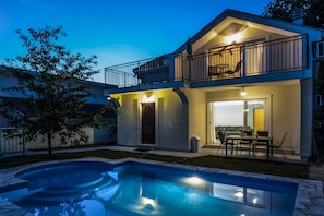 A two-story house with a balcony, a pool, and outdoor furniture. - 4 Bed Villa with Swimming Pool and Stunning Sea Views (Podi)