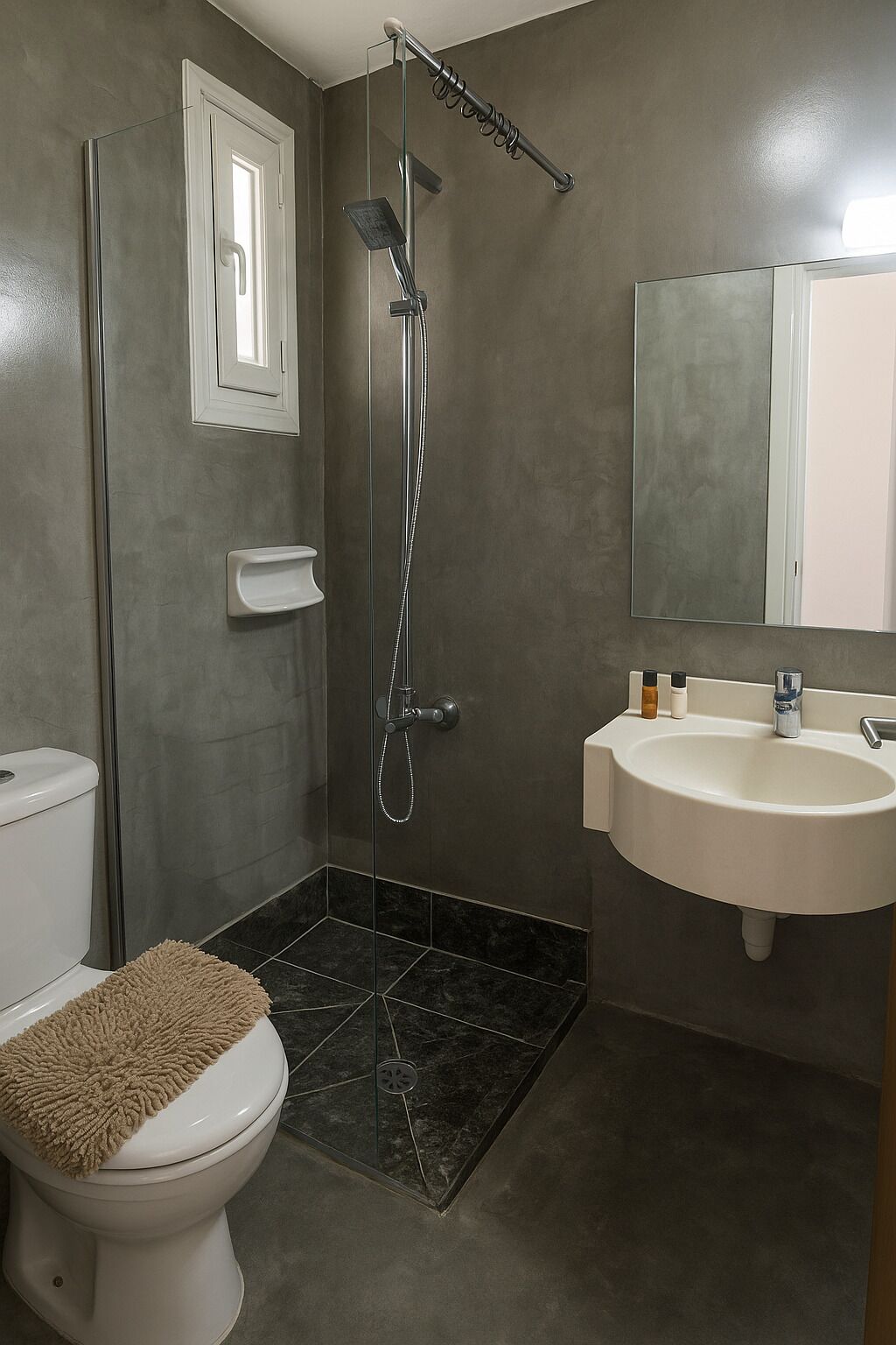 A modern bathroom with a shower, toilet, and sink.