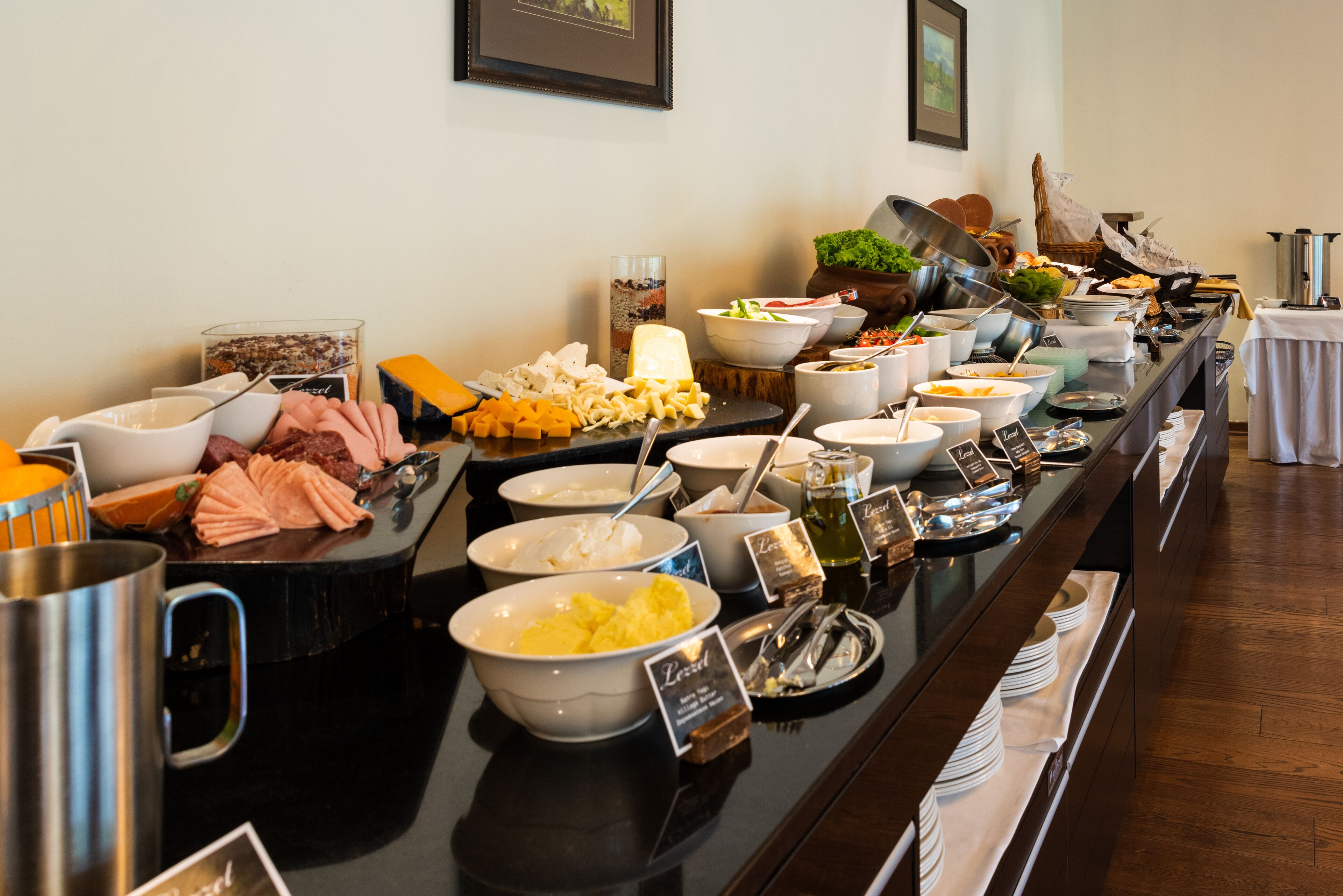 A buffet with various food items and condiments.