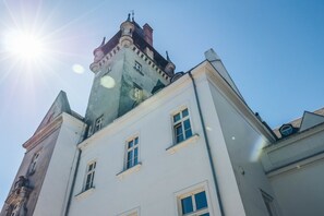 A historic building with a prominent tower and multiple windows.