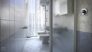 A modern bathroom with two toilets, a shower, and a sink. - Italianway Corso Lodi 121 (Milan)