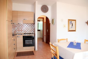 Apartment, 2 Bedrooms, Ground Floor | Private kitchen | Full-size fridge, oven, stovetop, espresso maker - Tanaunella Happy Sardinia (Budoni)