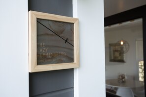 A framed artwork with text and a bird silhouette on a wall.