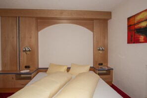 Classic design with a large bed, arched headboard, and two bedside tables.