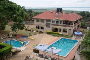 Un hotel con piscina, zona de estar al aire libre y vistas al paisaje.