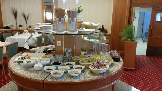 A buffet setup with various food items and a glass display case.