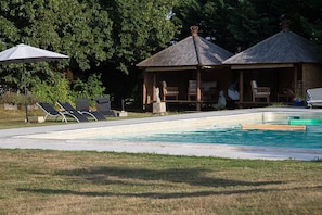 Seasonal outdoor pool, open 10:30 AM to 8:00 PM, pool umbrellas