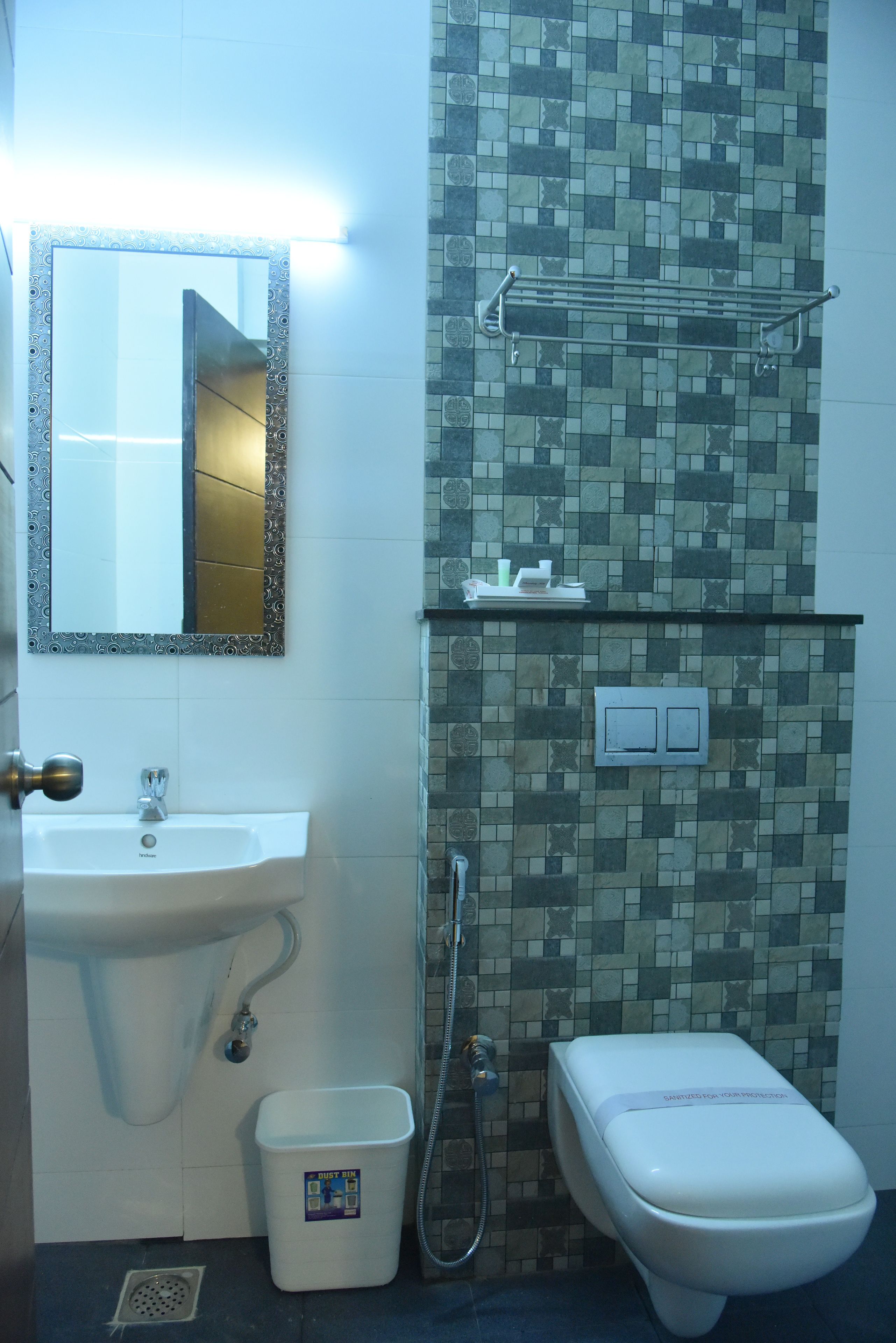 A bathroom with a sink, mirror, toilet, and shower.