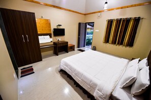 A bedroom with a bed, a wardrobe, a television, and a window with curtains. - The Kanila Resort (Karjat)