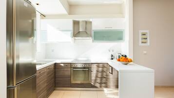 Deluxe Apartment, 2 Bedrooms, Pool View | Private kitchen | Full-sized fridge, oven, stovetop, coffee/tea maker
