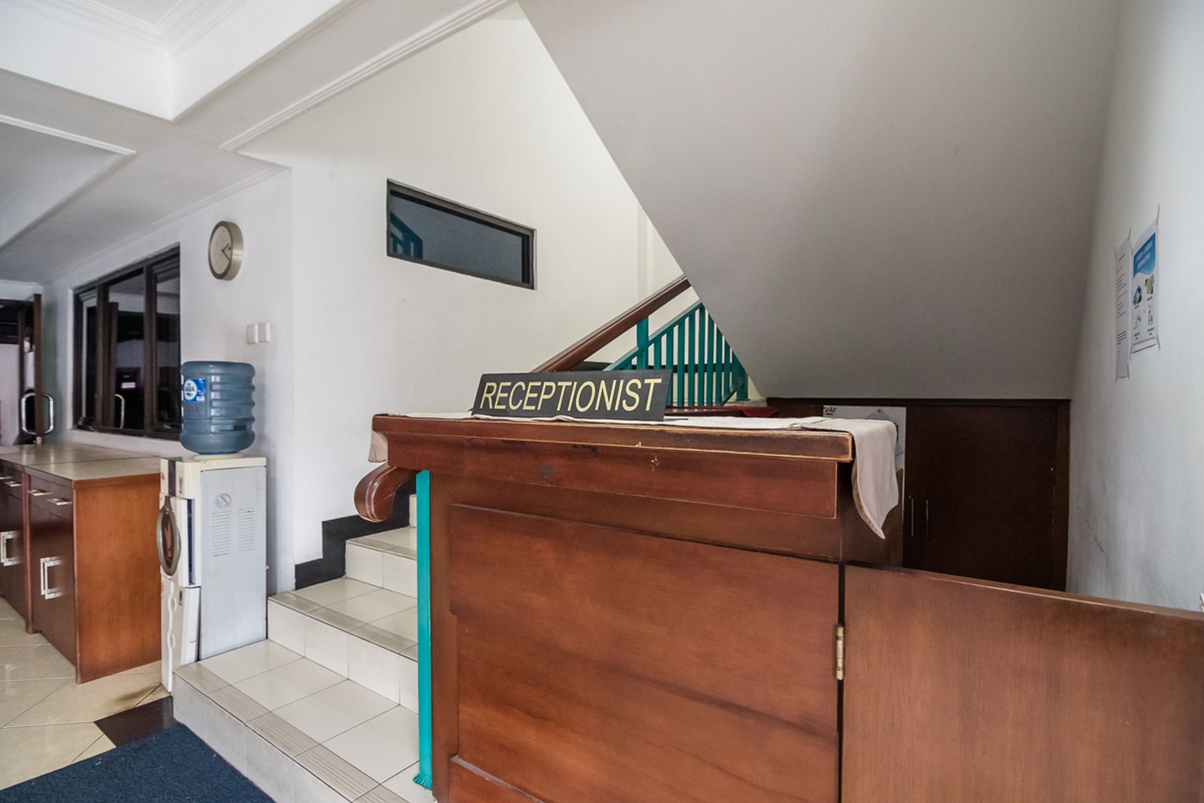 A reception desk with a sign reading "RECEPTIONIST" in a hotel lobby.