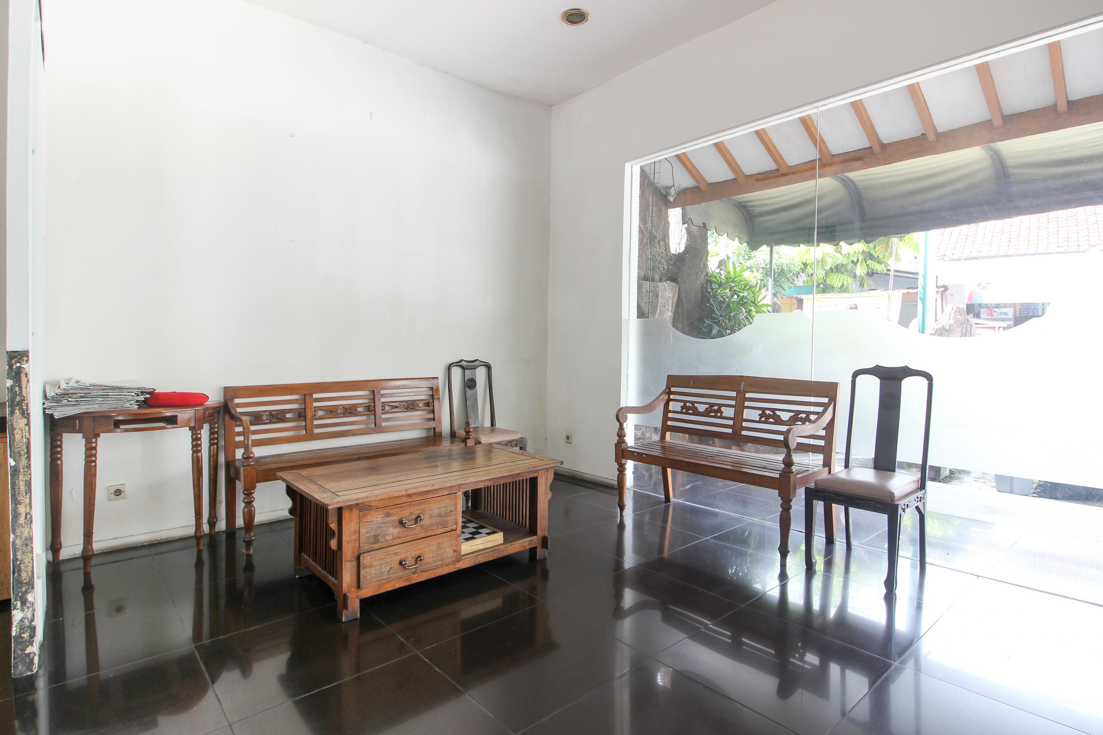 A room with a wooden bench, a small table, and a chair.